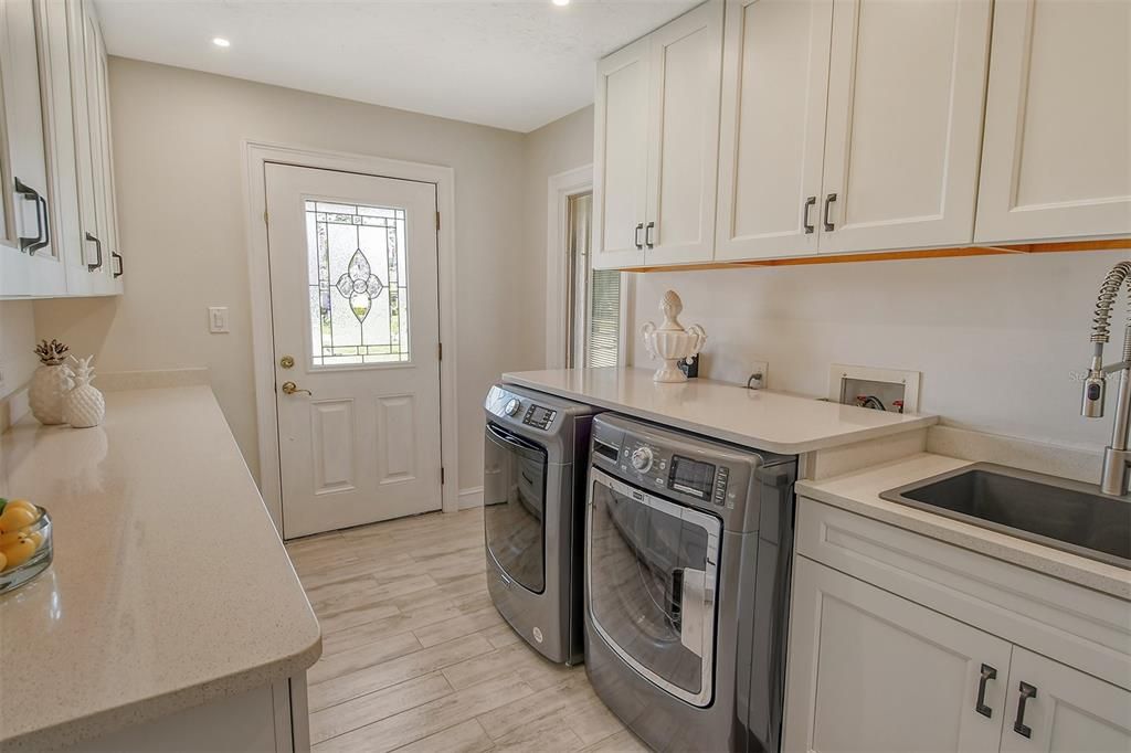 Convenient laundry room off the kitchen, a lot of storage, counter space and door to the exterior.