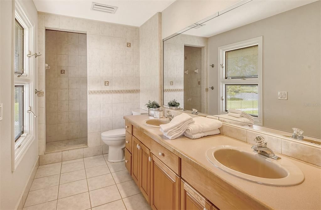 This bathroom has dual sinks and walk-in shower and serves bedrooms 3 and 4.