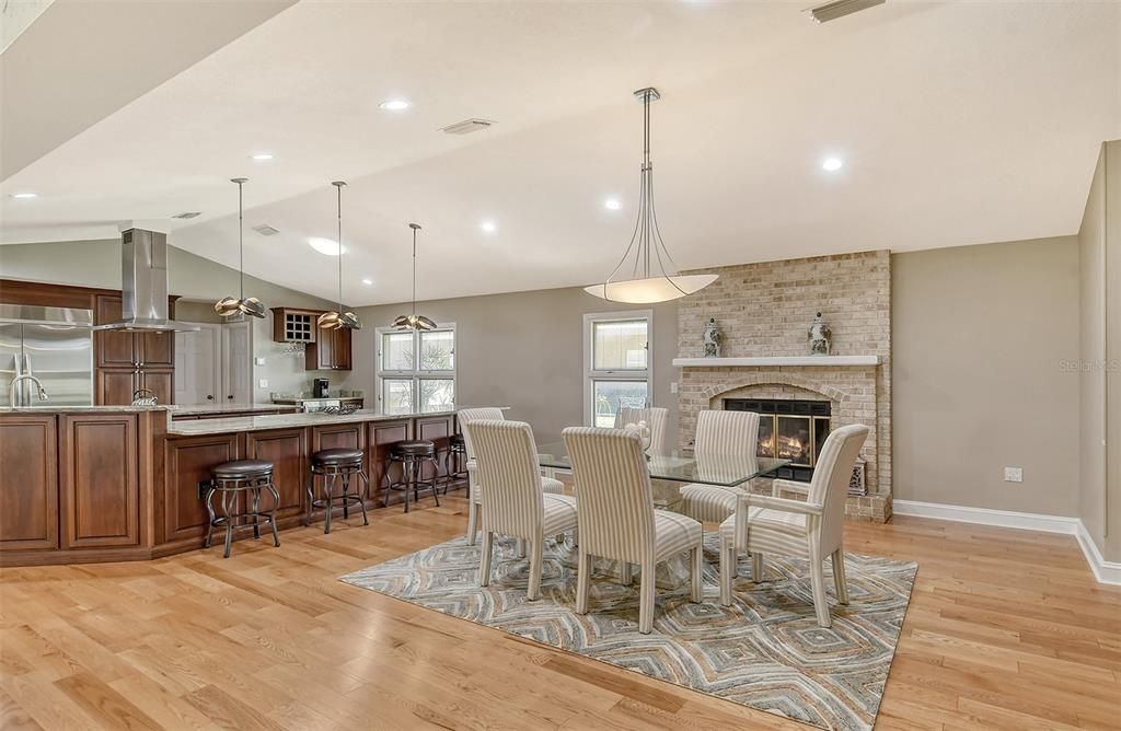 Dining room has fireplace, stylish chandelier.