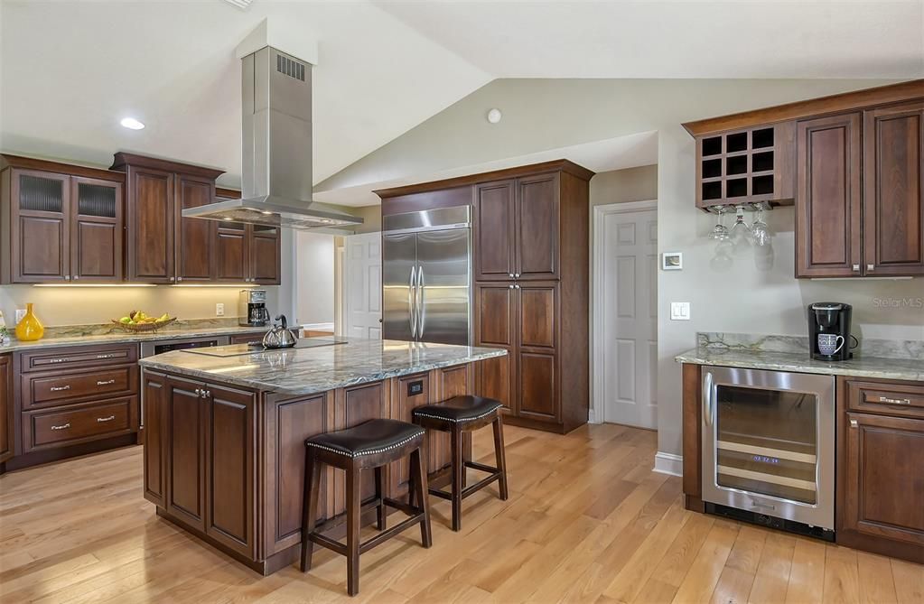 Stainless appliances, hood, and wine refrigerator.