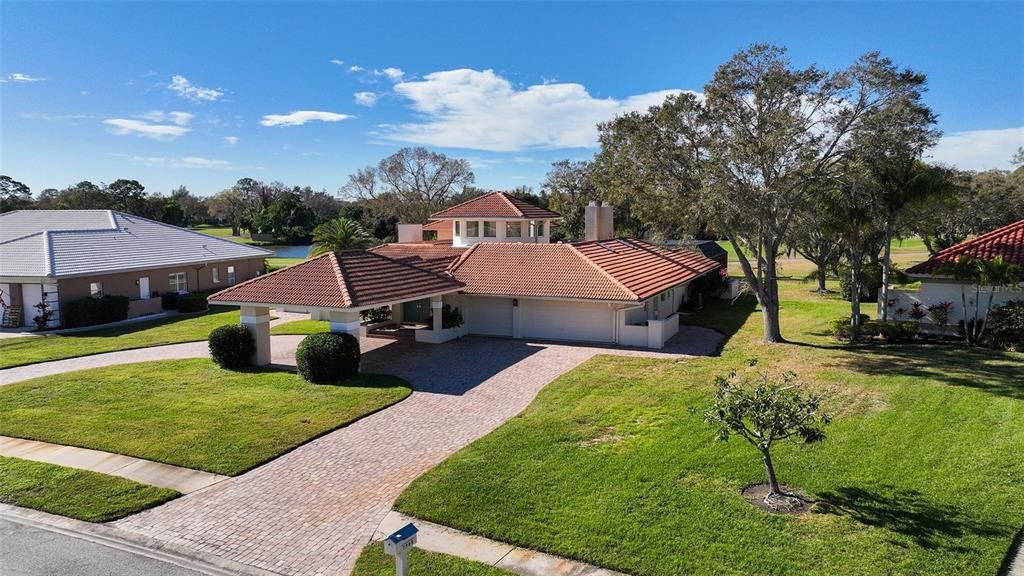 Portico at entry, 3 car garage with golf cart space.