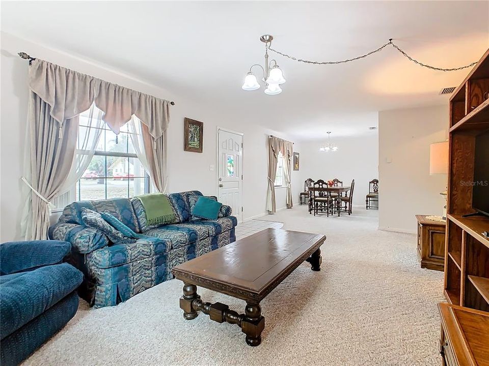 Living room looking to the front door and the formal dining room.