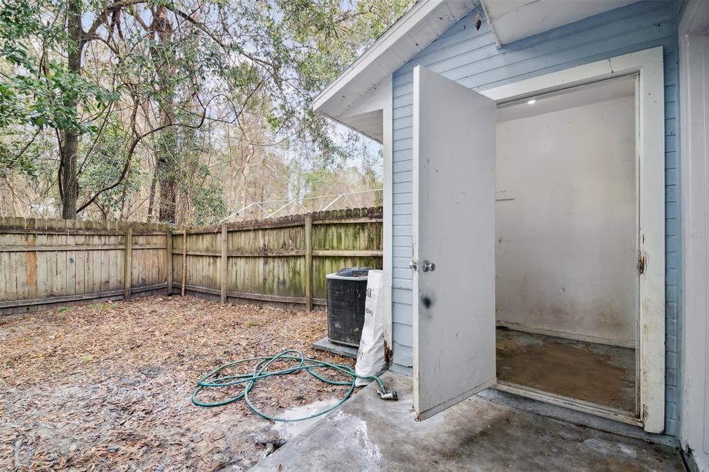 Laundry room and Fenced in backyard