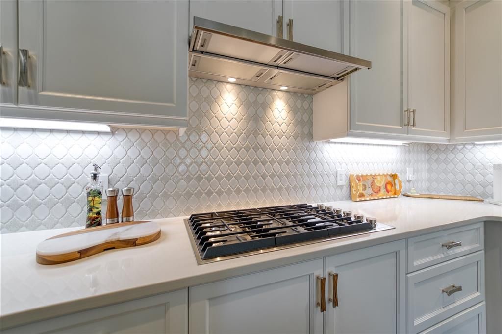 Impressive backsplash that compliments cabinetry and countertops.