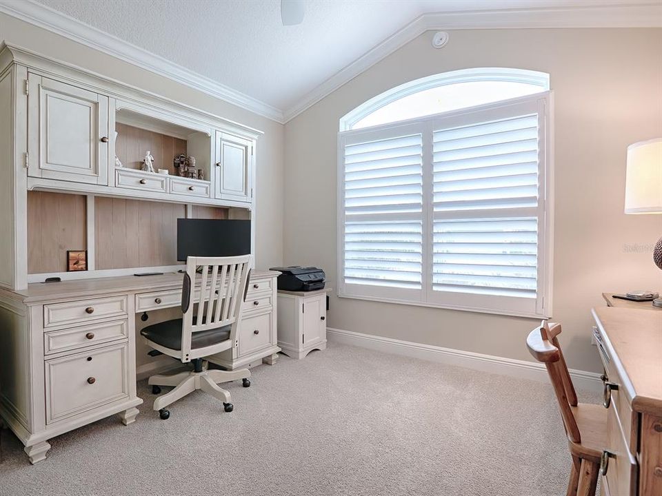 FRONT GUEST ROOM BEING USED AS AN OFFICE WITH VAULTED CEILINGS, LARGE DOUBLE WINDOW WITH TRANSOM. THIS ROOM DOES NOT HAVE A CLOSET.