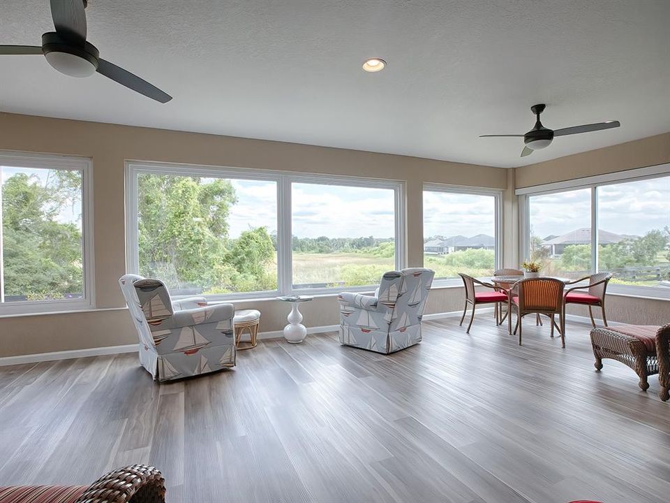 LUXURY VINYL PLANK FLOORING IN THE GLASS ENCLOSED LANAI.  WOW! WHAT A VIEW!