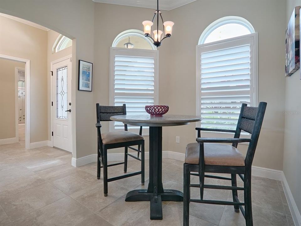 EAT-IN KITCHEN NOOK FOR CASUAL DINING WITH PLANTATION SHUTTERS WHICH YOU WILL FIND THROUGHOUT THE HOME.