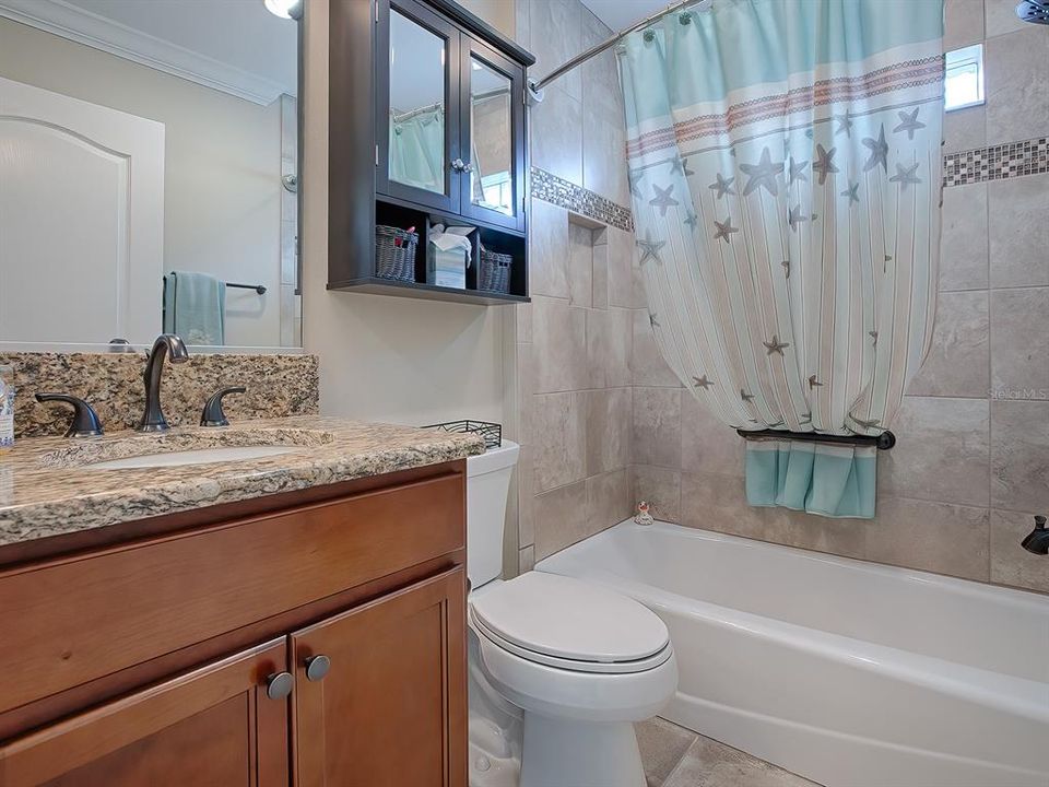 GUEST BATH WITH GRANITE COUNTERS, LOVELY TILE SHOWER AND TUB.