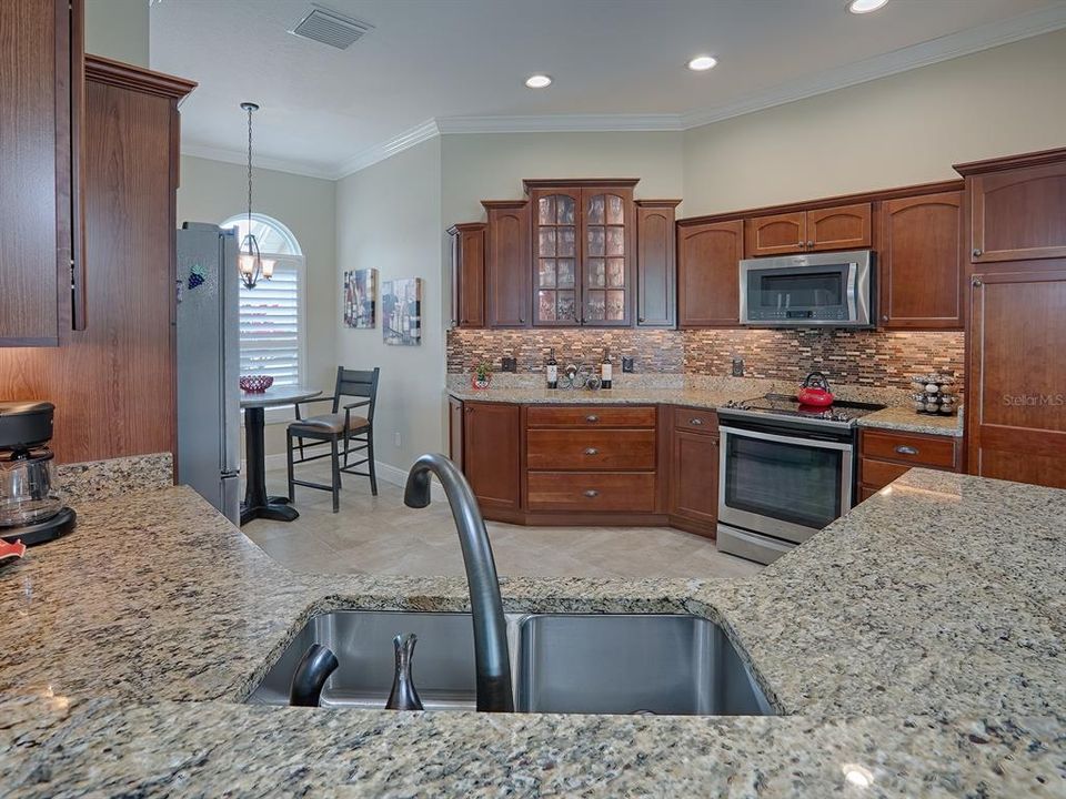 GRANITE COUNTER TOPS, GLASS TILE BACKSPLASH, AND UNDER COUNTER LIGHTING!