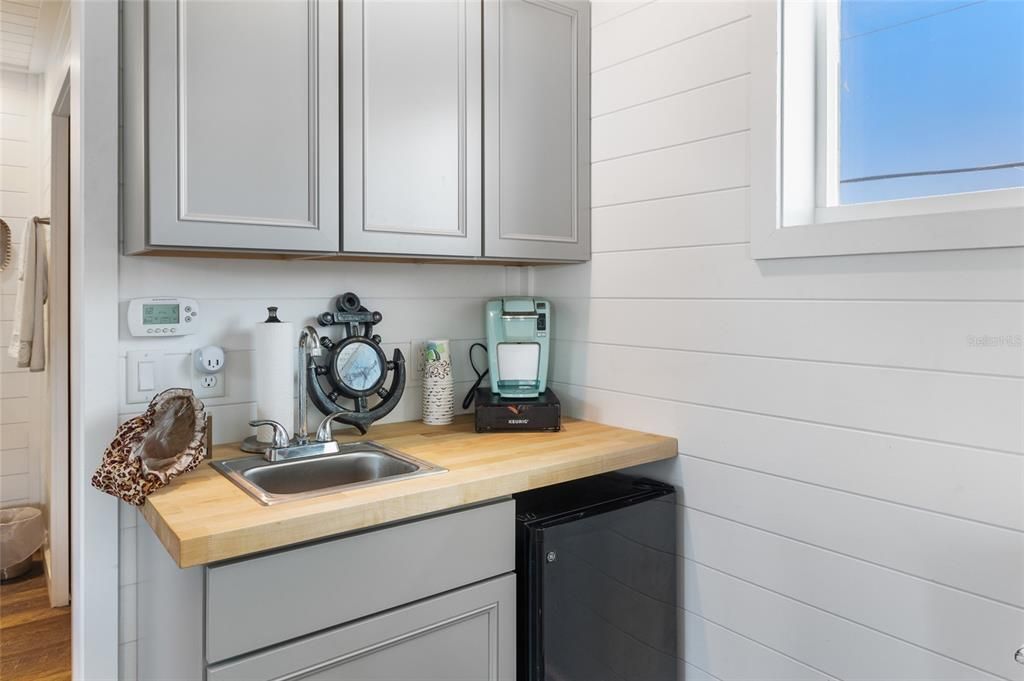 Primary suite offers mini refrigerator, sink, and coffee bar!