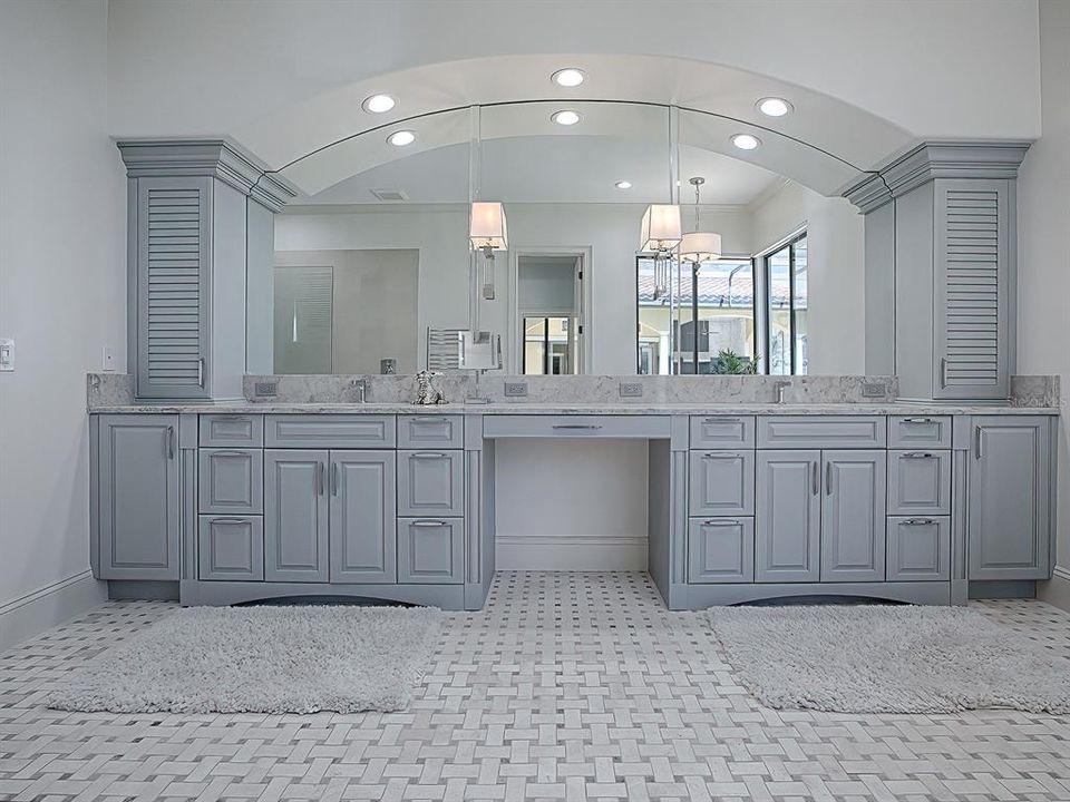 Remodeled primary bathroom with basket weave tile flooring, new fixtures and more.