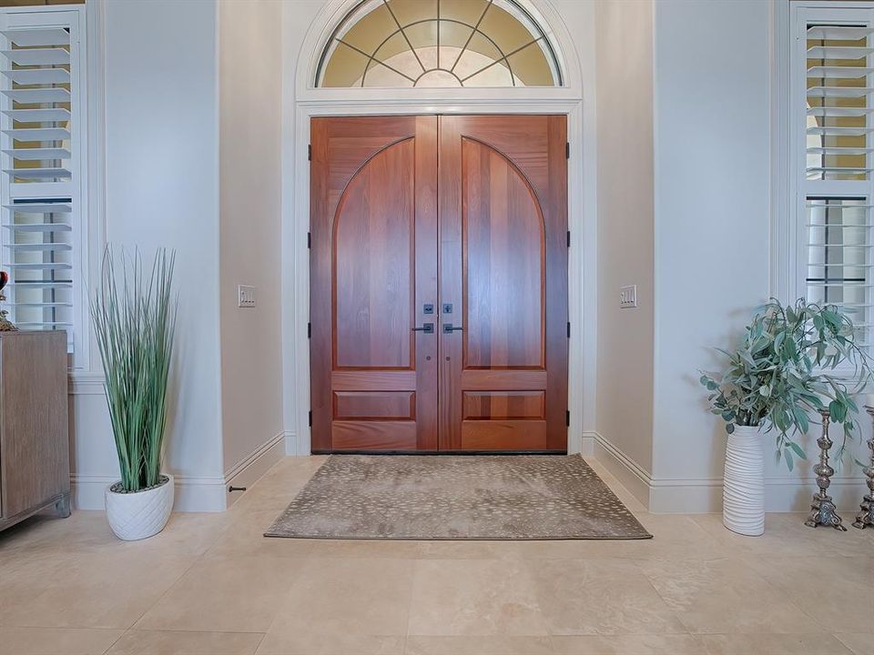 The foyer is filled with light and the travertine floors are throughout the home.