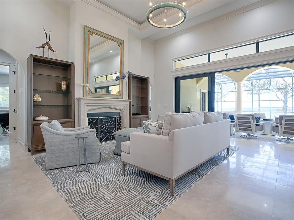 The living room offers 14' ceilings, custom moldings, and a ventless gas fireplace.