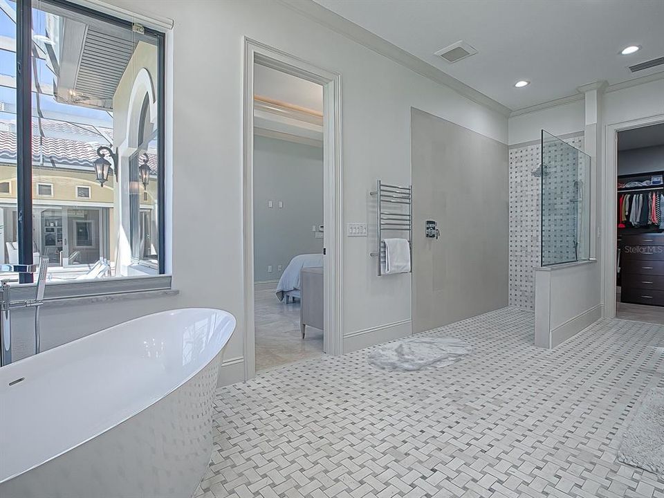 A heated towel bar and a custom walk-in shower with new fixtures.