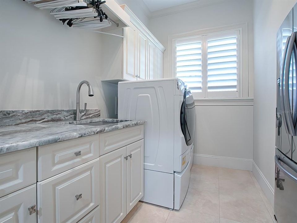 The laundry room comes with washer & dryer, refrigerator, a pull-down Iron Away ironing board, and plenty of storage.