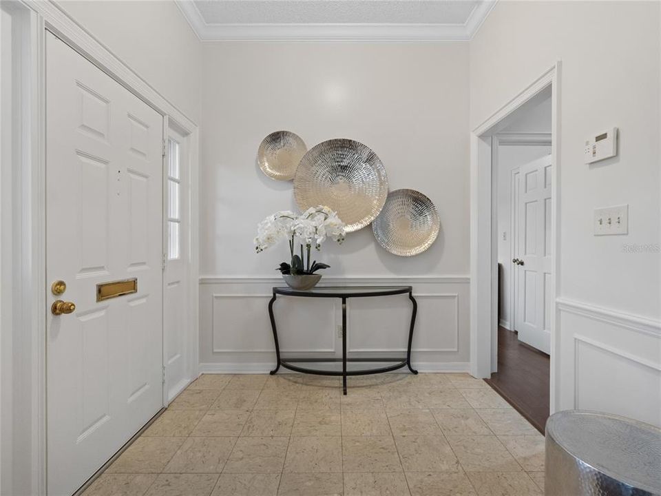Foyer with wainscoting and crown molding
