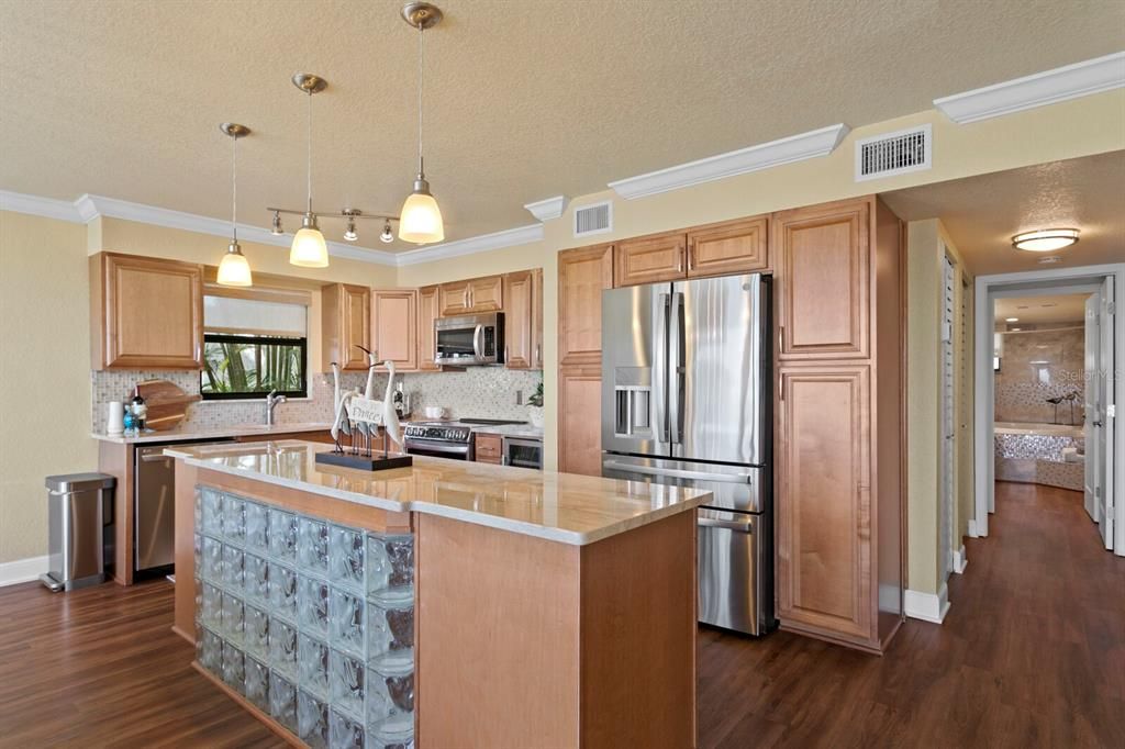 Enter into your beach home with its open floor plan design and an abundance of natural Florida light. Crown Molding, newer LVP flooring, newer windows and newer custom doors.