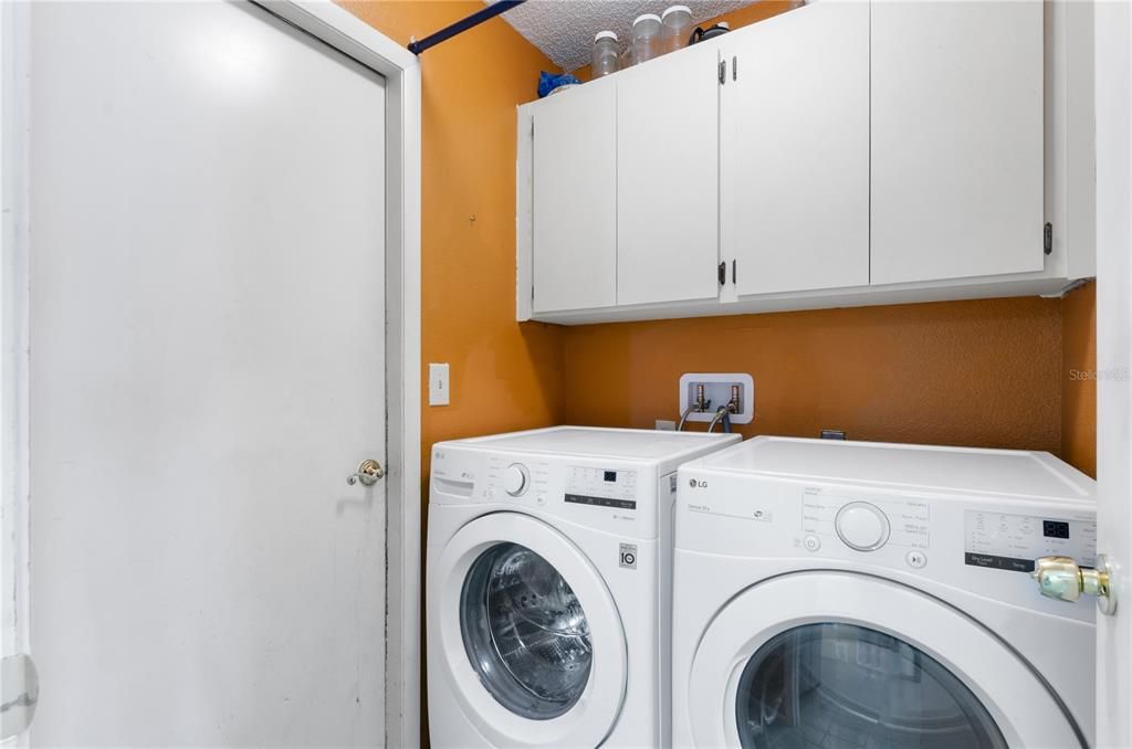 Inside laundry room with newer washer and dryer