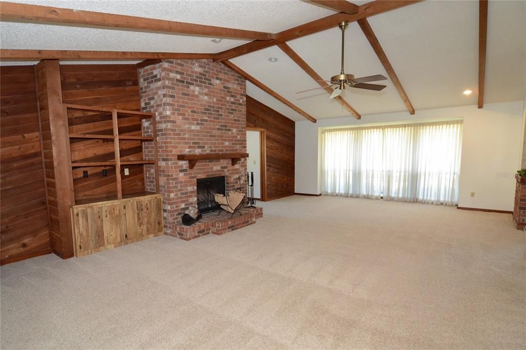 Bright & open family room with a lovely brick mantle & wood burning fireplace