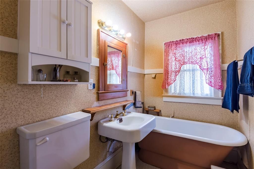 Upstairs bathroom has a clawfoot tub original to the home.