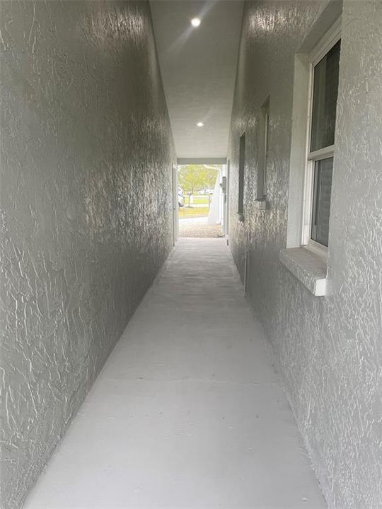 Hallway to carport/ workshop building