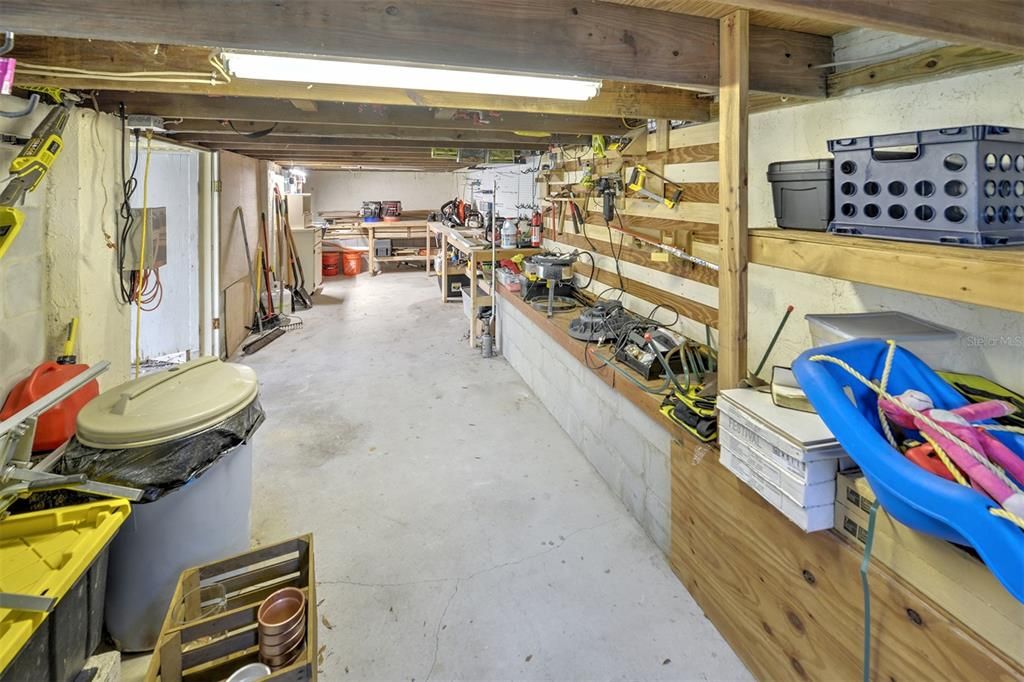 Unfinished basement being used as a workshop with electricity
