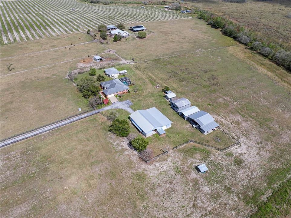 Drone showing house, barn, second house and covered storage