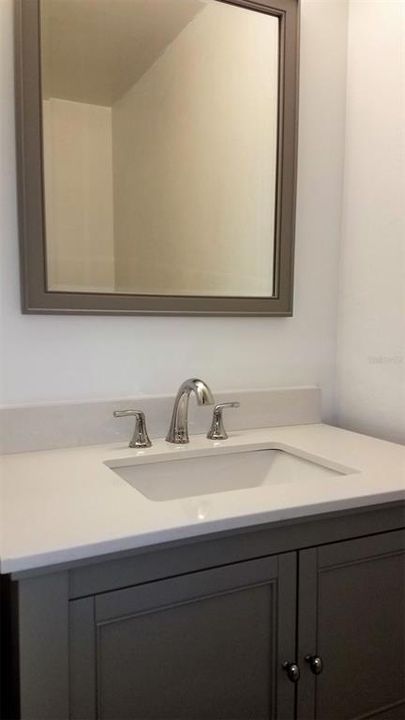Full Bath with updates vanity, mirror and lighting.