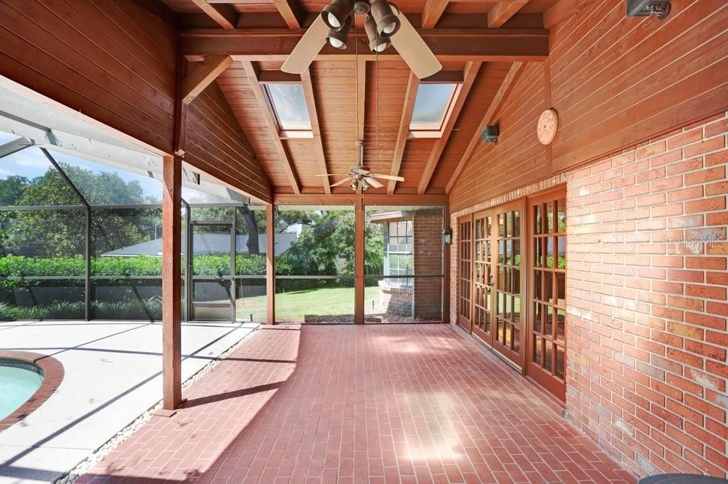 The covered back porch features brick pavers, two ceiling fans and four skylights for added light.