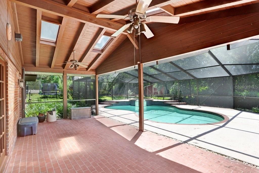 The covered back porch features brick pavers, two ceiling fans and four skylights for added light.