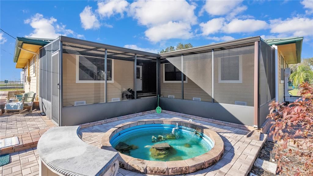 Serene koi pond with pump viewable through screened patio