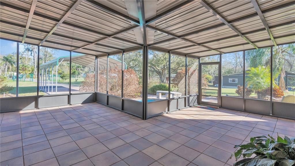 Enclosed screen patio overlooking koi pond and front yard