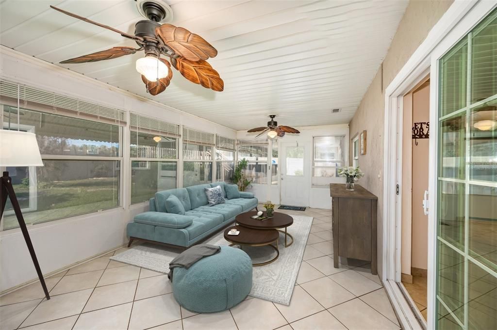 Virtually Staged-Enclosed 4 Season Porch, with awnings to block out the summer heat. Two Ceiling Fans to cool off the area on the warm summer days.