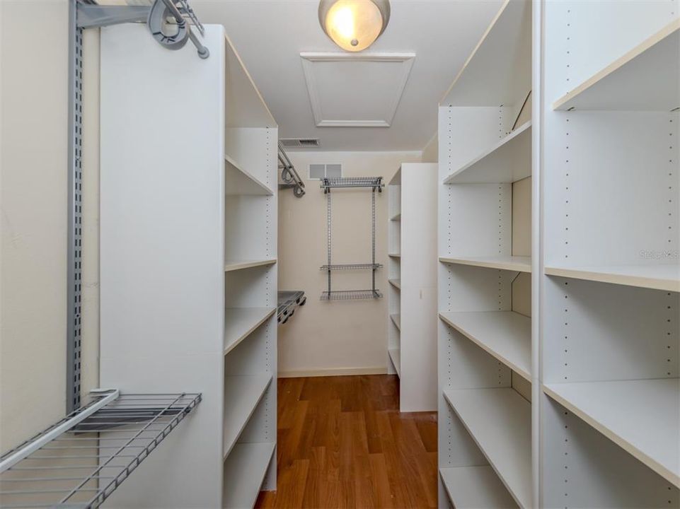 Stay organized with this lovely walk in closet with the convenience of built in shelving and adjustable clothes hanging racks. Main Bedroom.