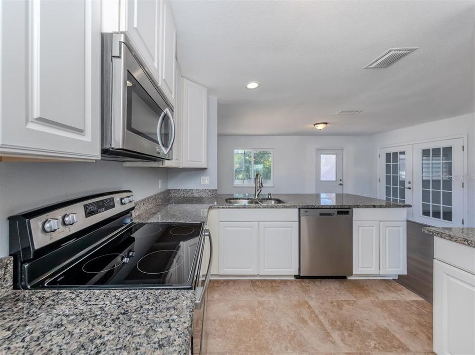 The efficient kitchen is the heart of the home and is connected to the family room with a granite breakfast bar.