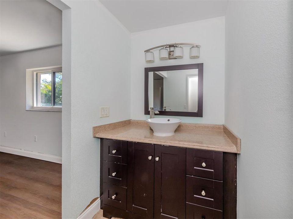The main bathroom is connected to the bedroom and has this separate little dressing area with a door to the bathroom.