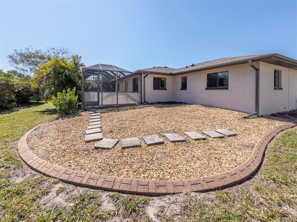 The back yard, and the gardens around the home are curbed and ready for fresh plantings of your choice! Imagine the outdoor space of your dreams!