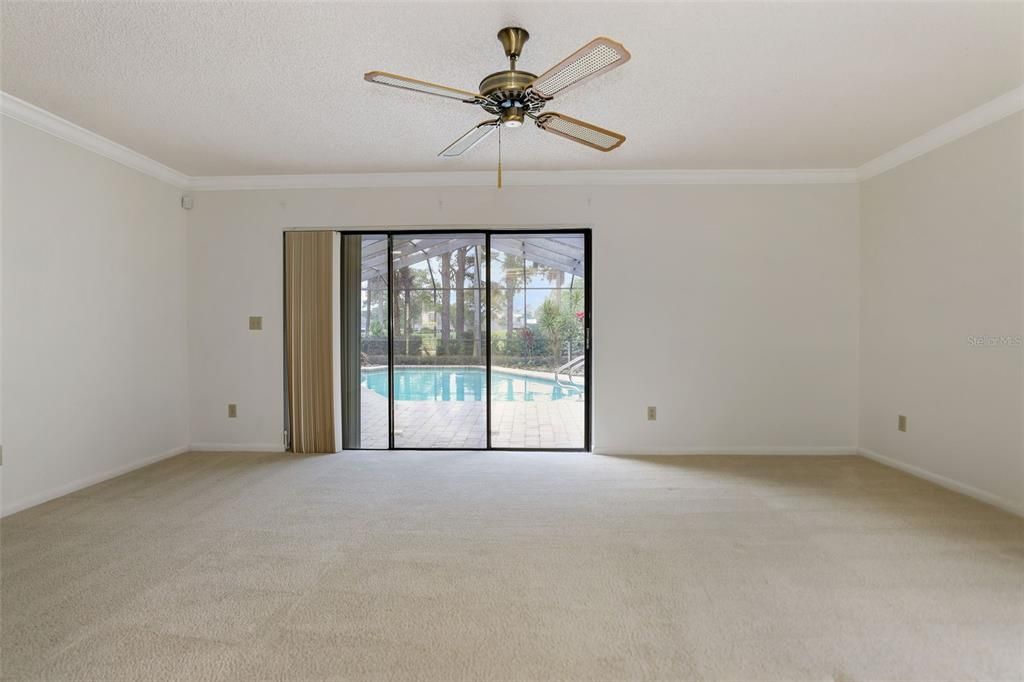 Spacious Primary Bedroom with Sliding glass doors lead to the lanai and heated pool