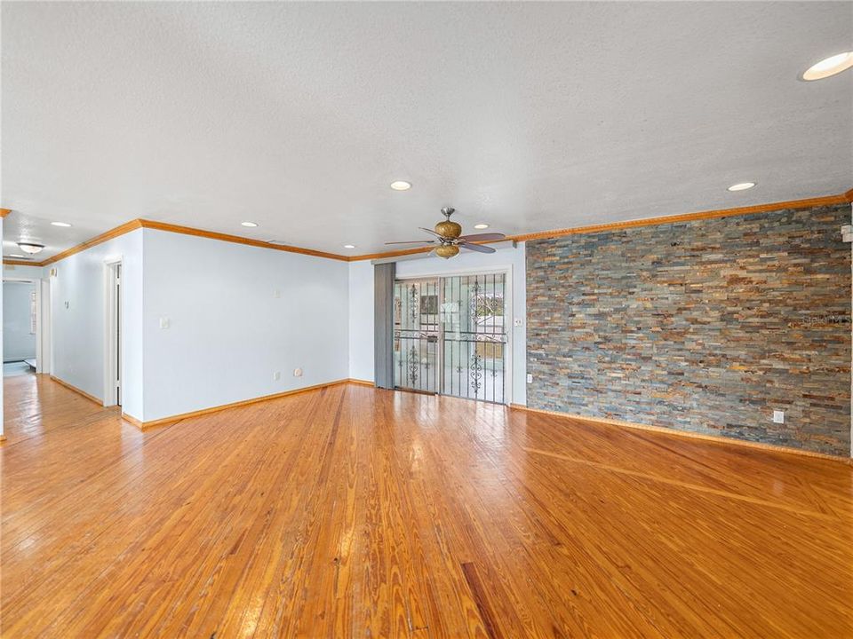 Living room view showing the stone wall accent to the right.