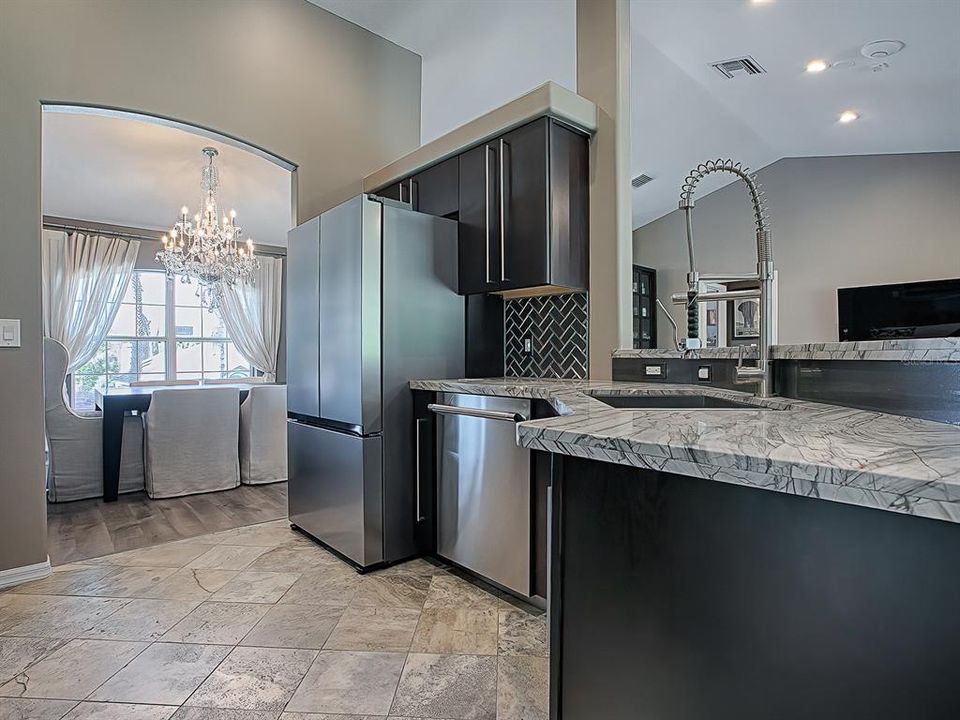 This updated kitchen also offers a super quiet Thermador dishwasher, a new refrigerator, and the counter tops are quartzite.