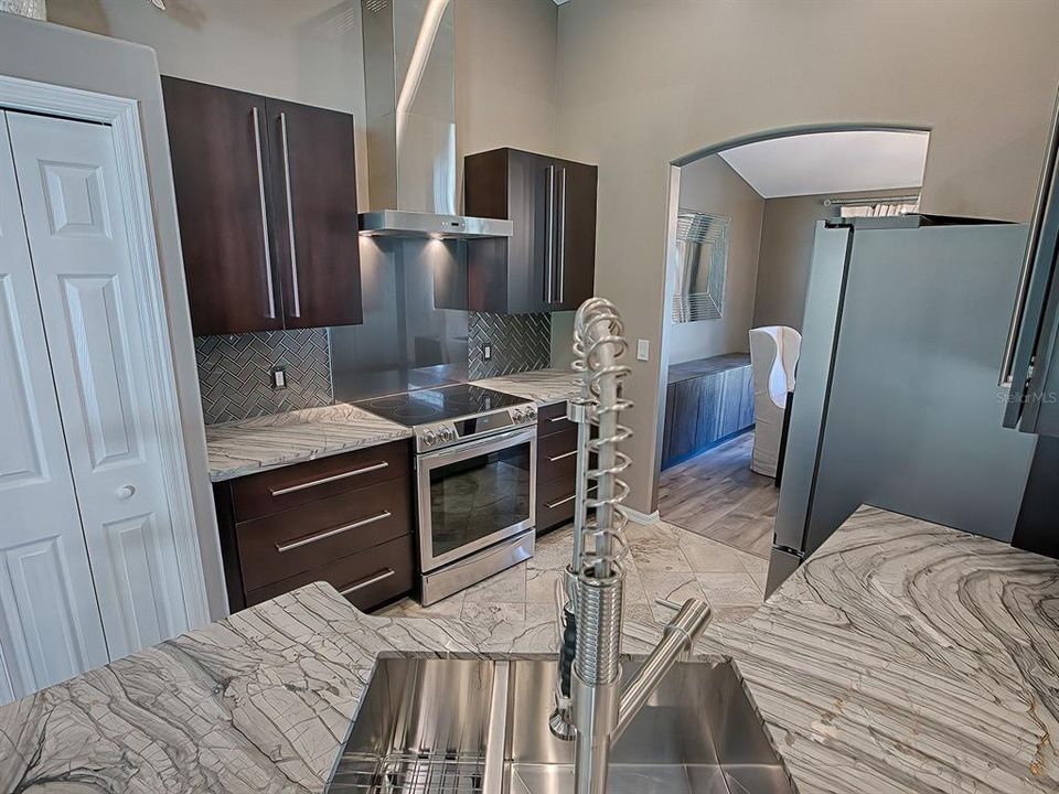Accented by a commercial style kitchen faucet fixture.