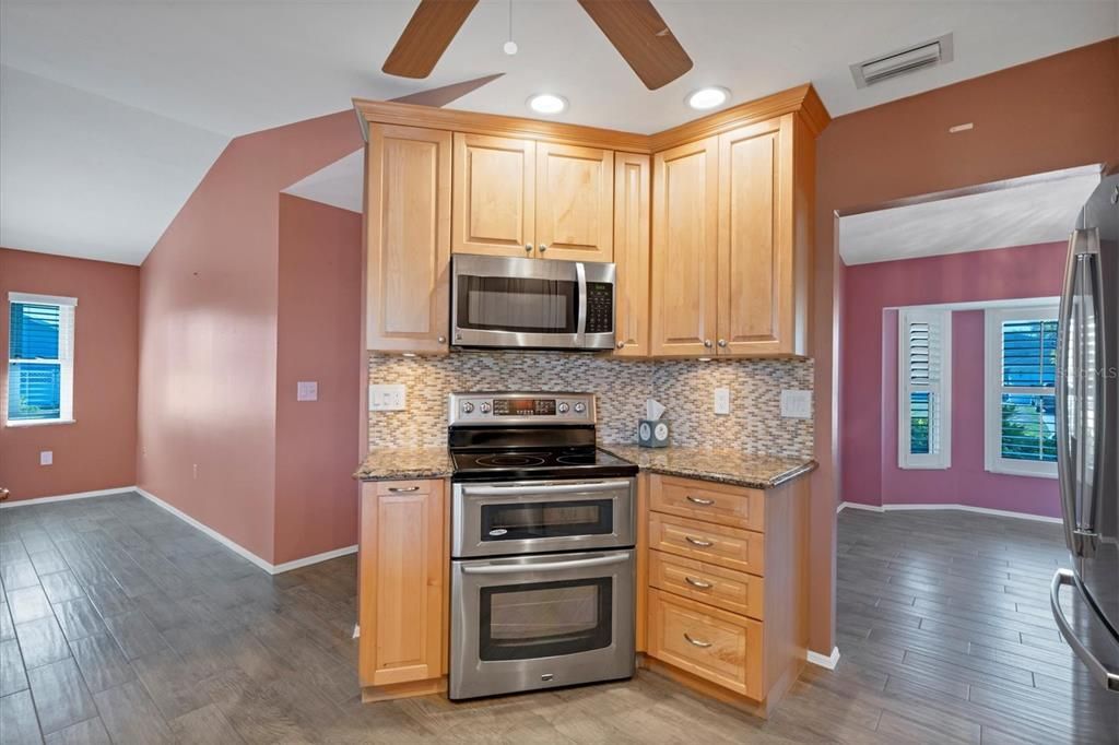 KITCHEN SHOWING DINING TO FAR RIGHT AND FAMILY ROOM FAR LEFT