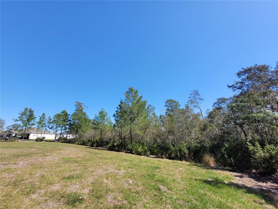 View of front of land showing house to the left side.