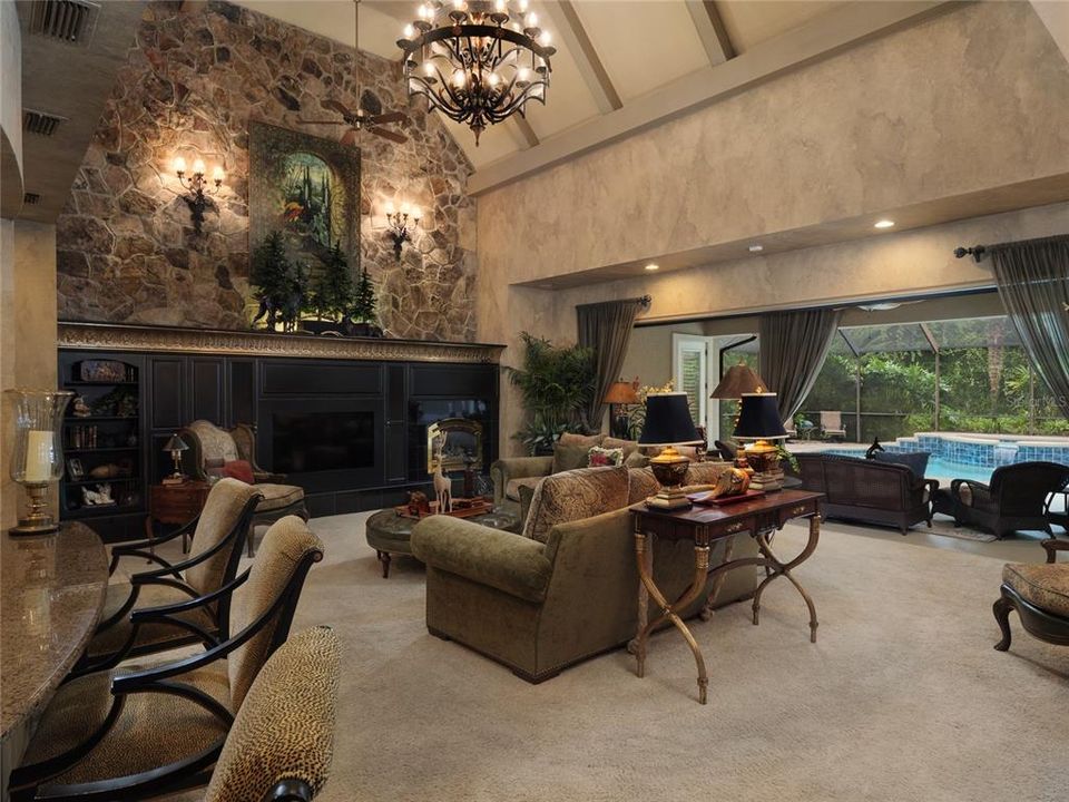 GRAND GREAT ROOM WITH STONE WALL, RETRACTABLE SLIDERS