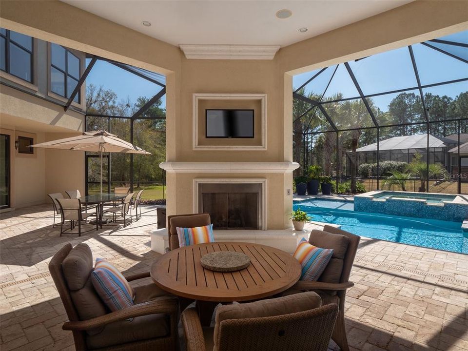 AMAZING LANAI AREA WITH TRAVERTINE PAVERS, GAS FP, SUMMER KITCHEN AREA