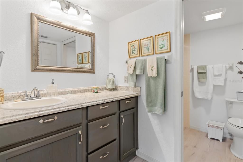Primary ensuite Bathroom with spacious vanity, walk-in shower and pocket slider for privacy