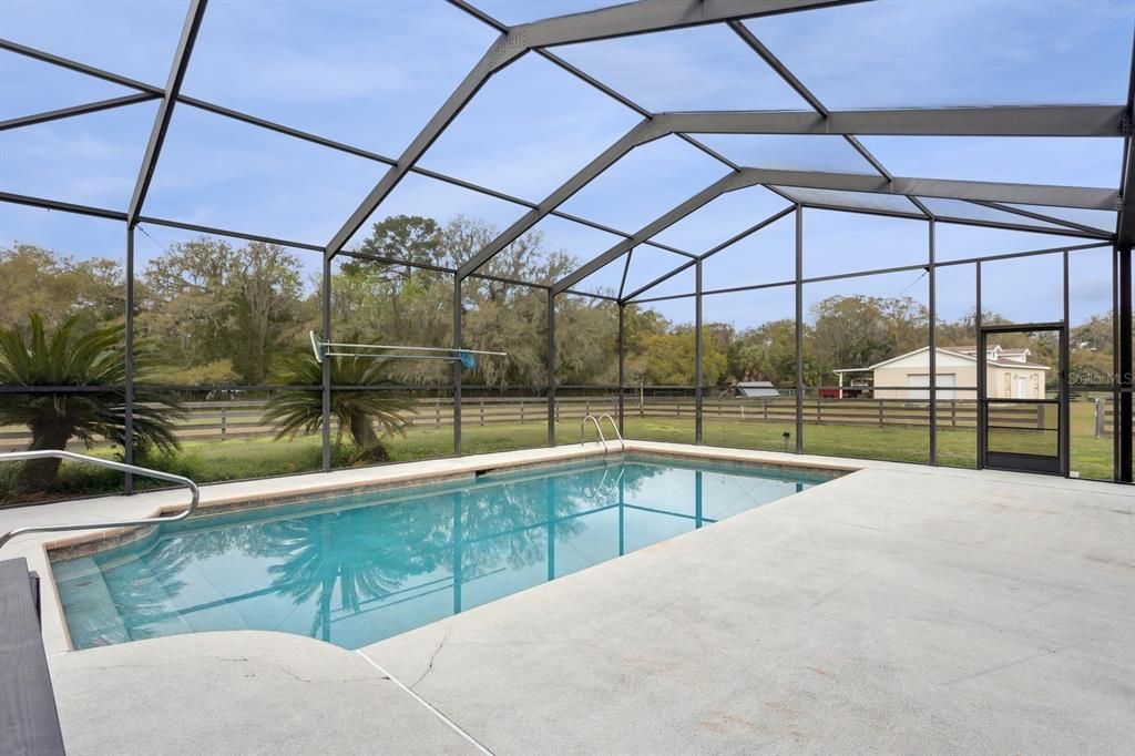 Screened in Heated pool with views of the acreage