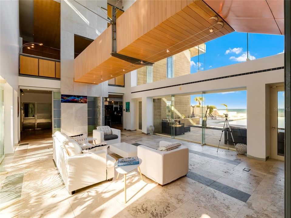 Soaring 33-foot ceiling and glass walls showcasing the picturesque ocean view.