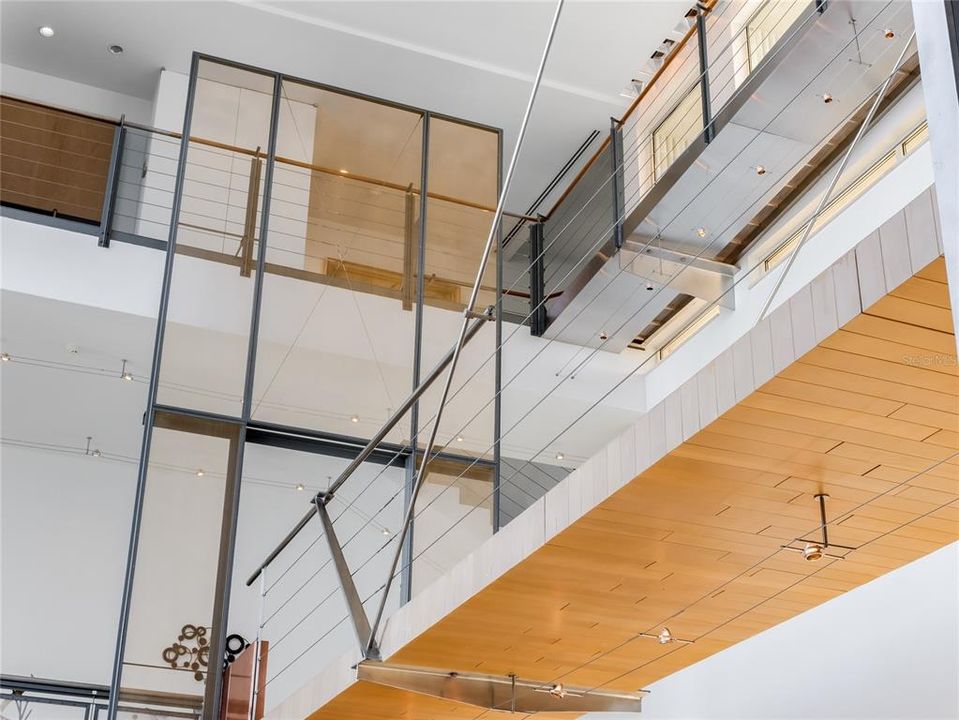 The second and third floors are connected by bridges overhead, adding to the unique and modern design of the home.