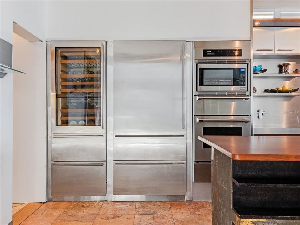 Thermador double wall oven, dishwasher, Sub-Zero refrigerator, and a wine refrigerator.